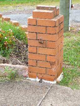 Repaired brick fence post